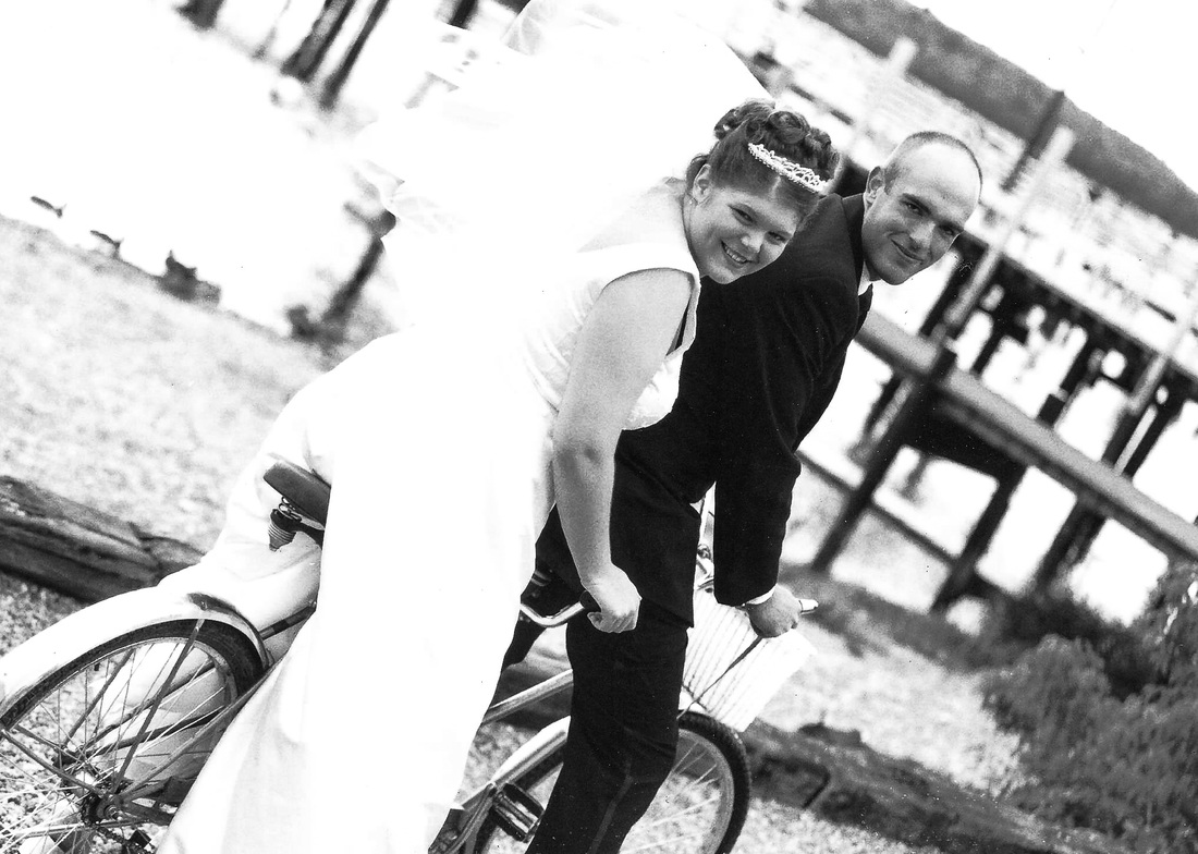 Bride and Groom ride a tandem bicycle